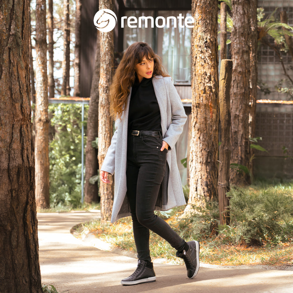 Womens at Marcia May - Image of a women wearing Remonte shoes with the Remote logo