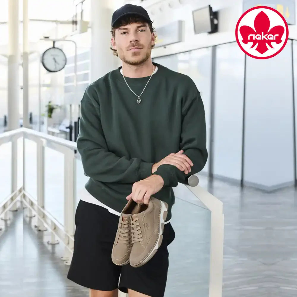 Mens at Marcia May - Image of a man wearing Rieker shoes with the Rieker logo