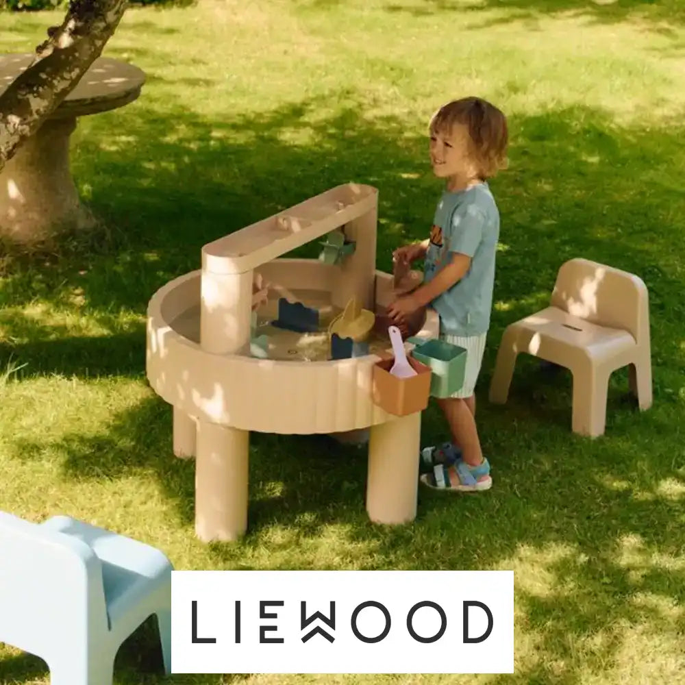 Image of a two children playing in a blanket fort alongside the Liewood logo
