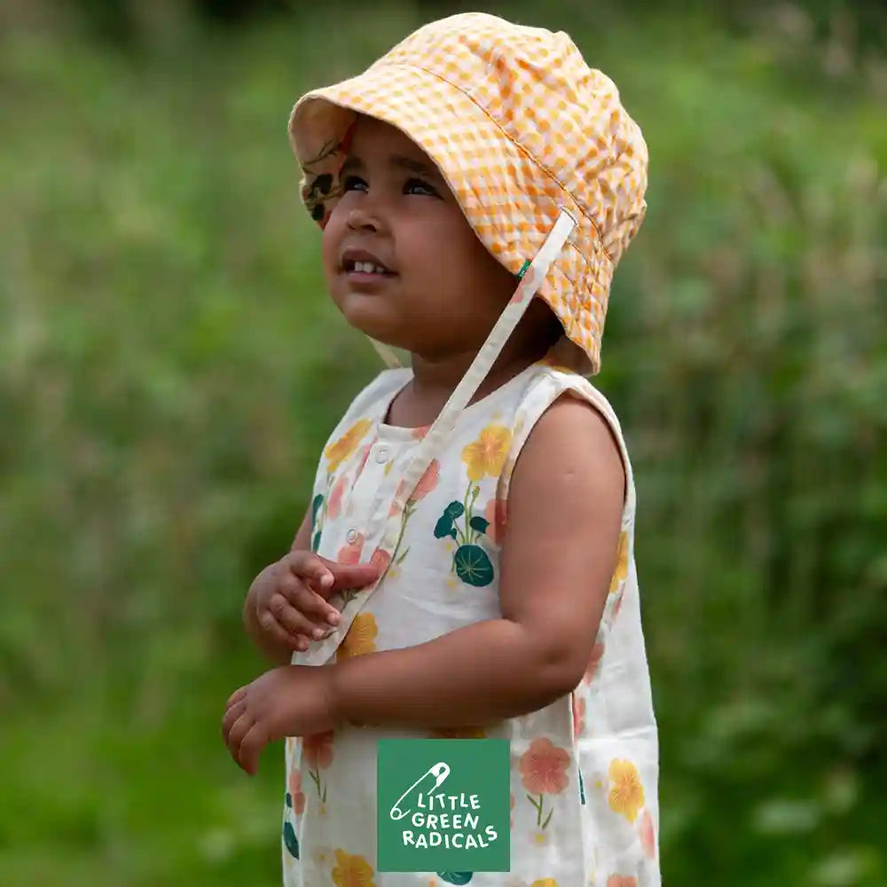 Image of a two children wearing a Little Green Radicals clothes, alongside the Little Green Radicals logo