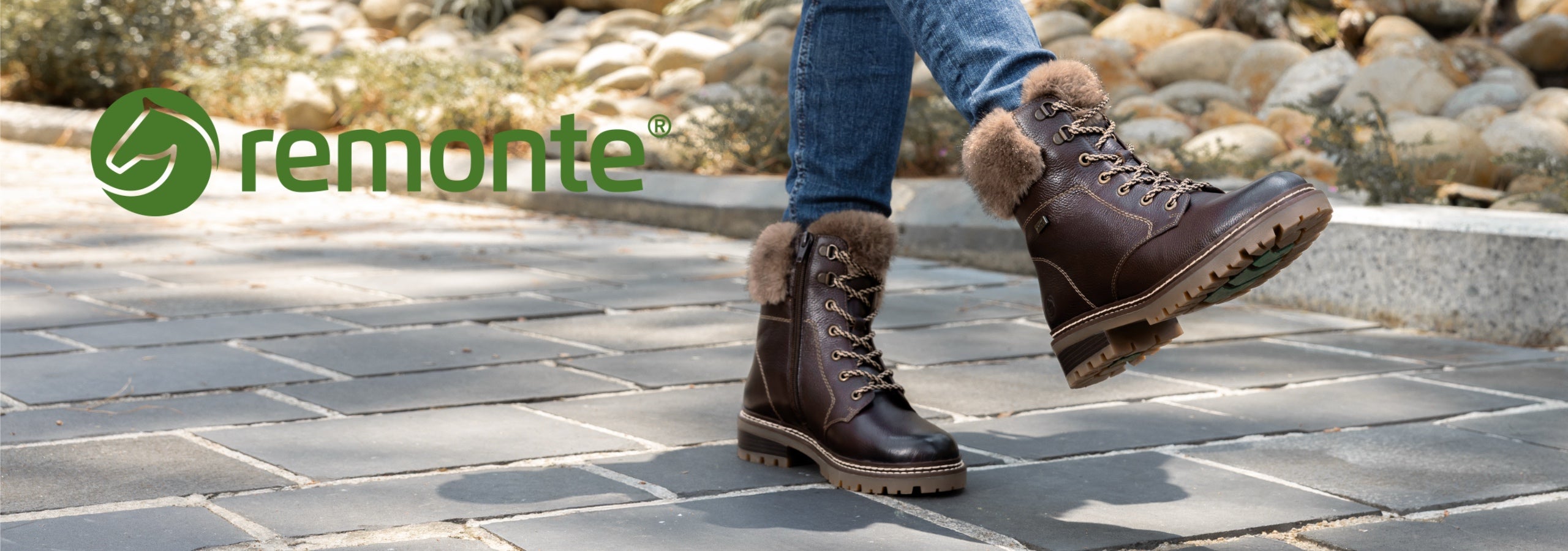a pair of brown remonte boots with fur style lining and a green remonte logo